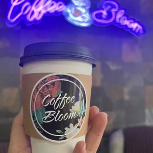 a hand holding a cup of coffee