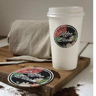 a cup of coffee on a wooden tray