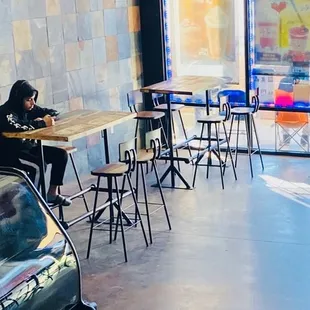 a woman sitting at a table in a coffee shop