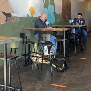 people sitting at tables in a coffee shop