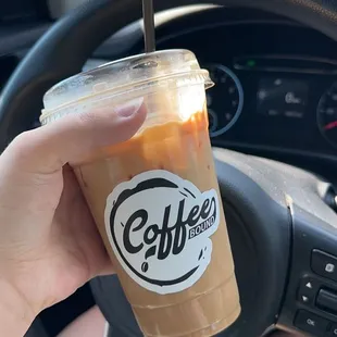 a hand holding a cup of coffee