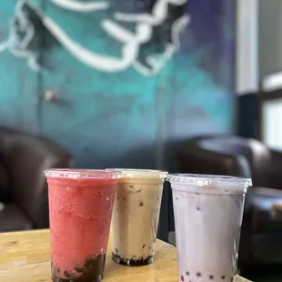 three different drinks on a table