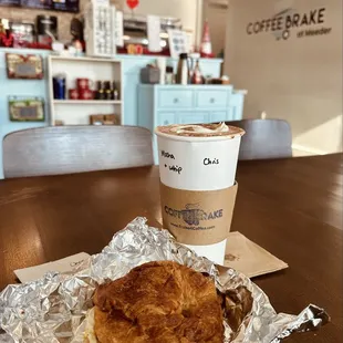 Large mocha with bacon egg and cheese croissant sandwich.