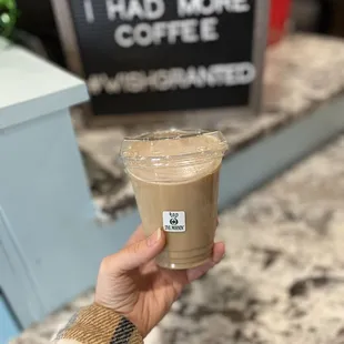 a hand holding a cup of coffee