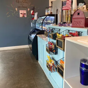 a coffee shop counter with a variety of items