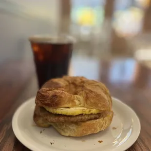 Sausage &amp; egg on croissant and cold brew coffee