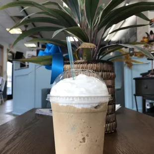 a cup of iced coffee on a table