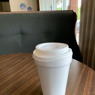 Hot coffee is served in ugly styrofoam cups with lids that don't fit.