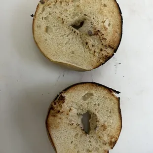 a half eaten bagel on a cutting board