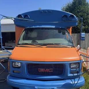 an orange and blue gmc van