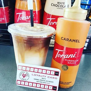 a cup of coffee and a bottle of caramel