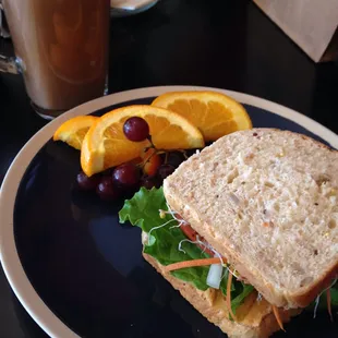 Hummus sandwich with fruit, and a chai latte