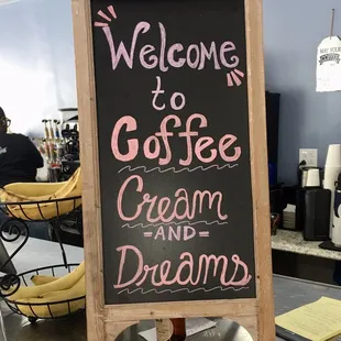 a welcome sign for a coffee shop