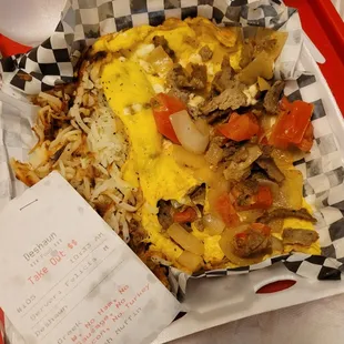 an omelet, rice, and vegetables in a basket