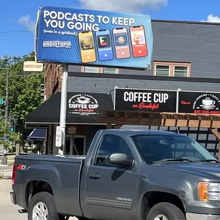 a truck parked in front of a coffee shop