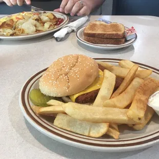 a burger and fries on a plate