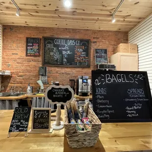 a coffee shop counter with chalkboard menus