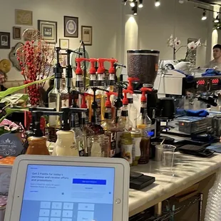a coffee shop with a laptop on the counter