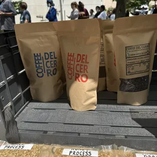three bags of coffee sitting in the back of a truck