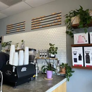 a coffee shop counter with a variety of coffees