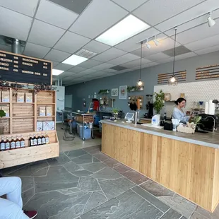 a woman sitting at a counter in a coffee shop