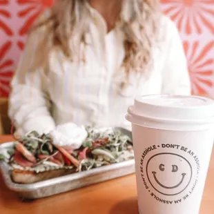 a woman sitting at a table with a plate of food