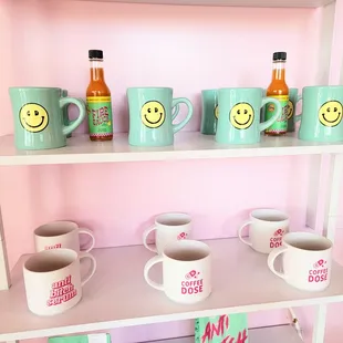 a shelf full of coffee mugs