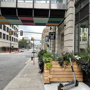 a scooter parked on the sidewalk