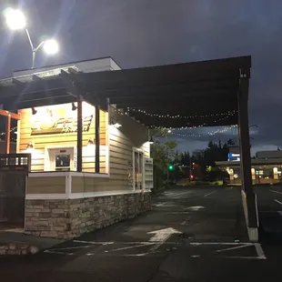 the outside of a coffee shop at night