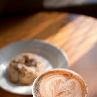 a cup of cappuccino and a plate of cookies
