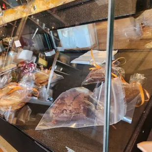 a display of pastries in a glass case