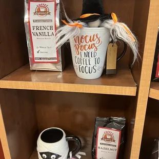 a shelf of coffee and a witch's hat