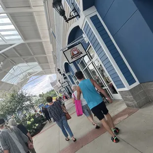 people walking down the sidewalk