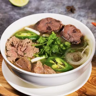 a bowl of soup with meat and vegetables