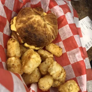 Bacon egg and cheese croissant with tater tots