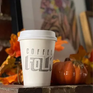 a cup of coffee on a brick ledge