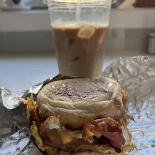 Bacon egg and cheese on an English muffin and an iced coffee