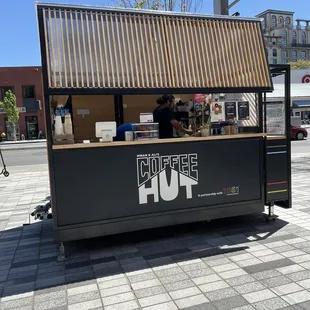 a man standing in front of a coffee shop