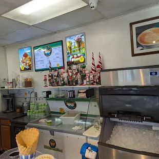 a coffee shop with a menu on the wall