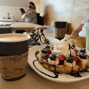 a plate of waffles and a cup of coffee