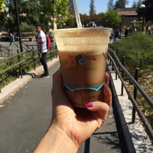 a hand holding a cup of coffee