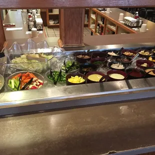 a variety of salads on the counter