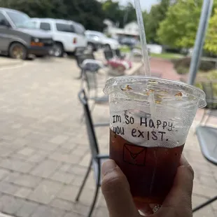 Enjoying a delicious Cold Brew sitting outside on a comfy armchair.