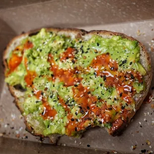 a piece of bread with guacamole on it