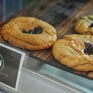 three cookies on display in a glass case