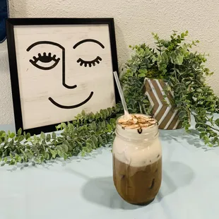  jar of iced coffee with a smiley face drawn on it