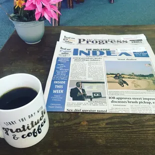  newspaper and a cup of coffee