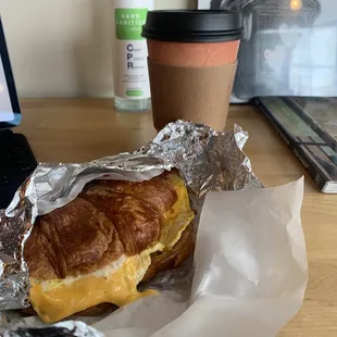 Sausage egg cheese on croissant with dirty chai