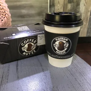 a cup of coffee next to a box