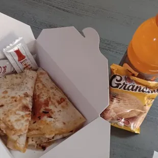 a sandwich in a box and a drink